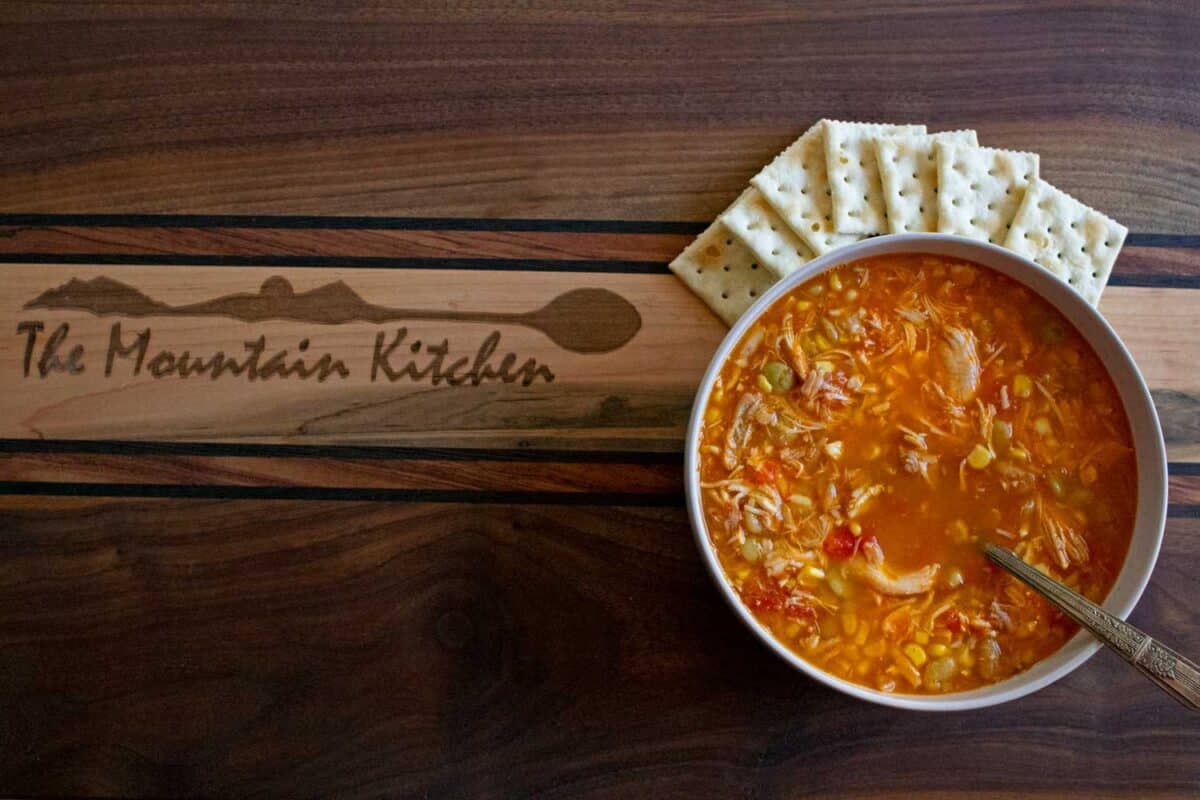 bowl of chicken vegetable soup with crackers