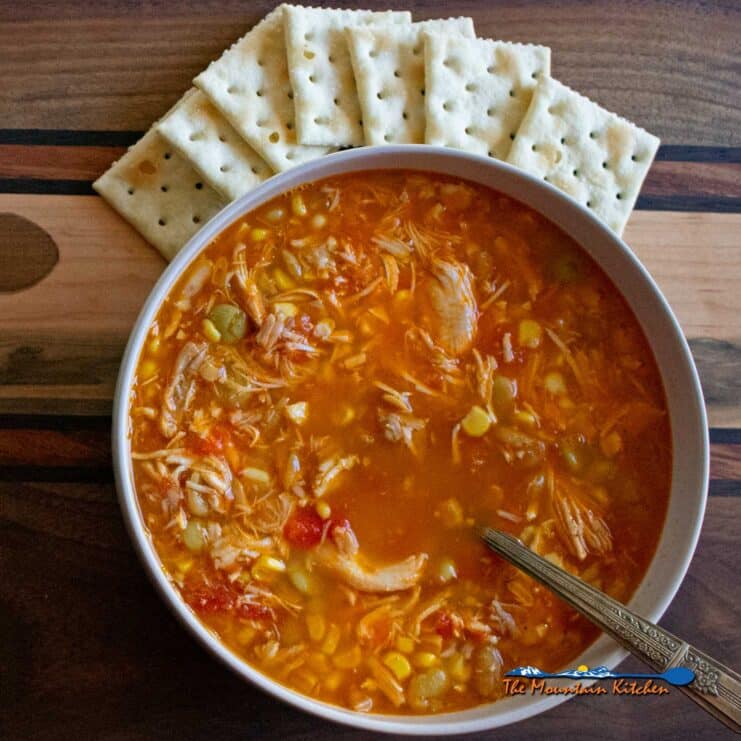 bowl of chicken vegetable soup in bowl with crackers
