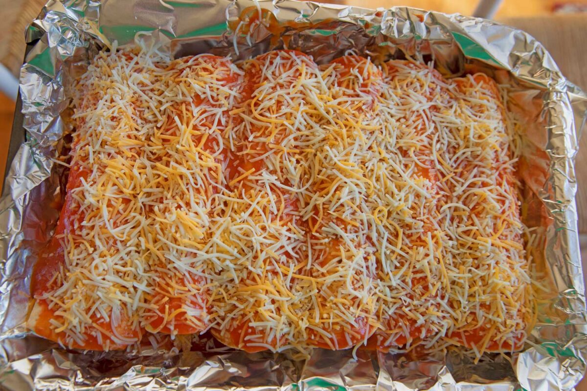 enchiladas in baking dish with foil