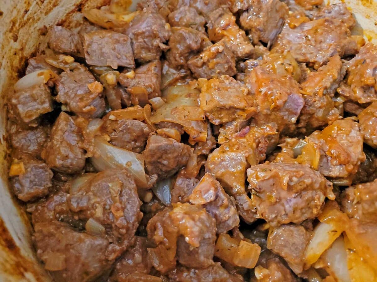 pot of venison meat onions and garlic