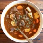 venison stew in a bowl with spoon
