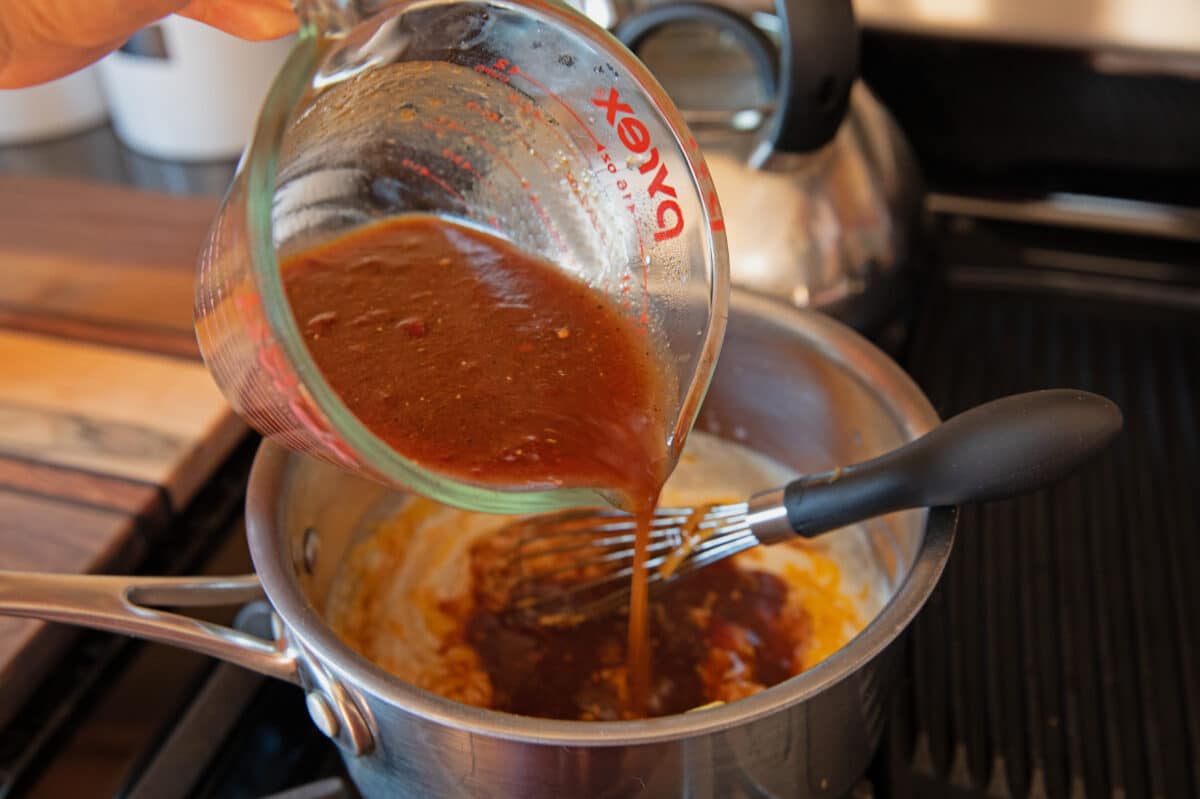 mixing bbq sauce base into cheese sauce