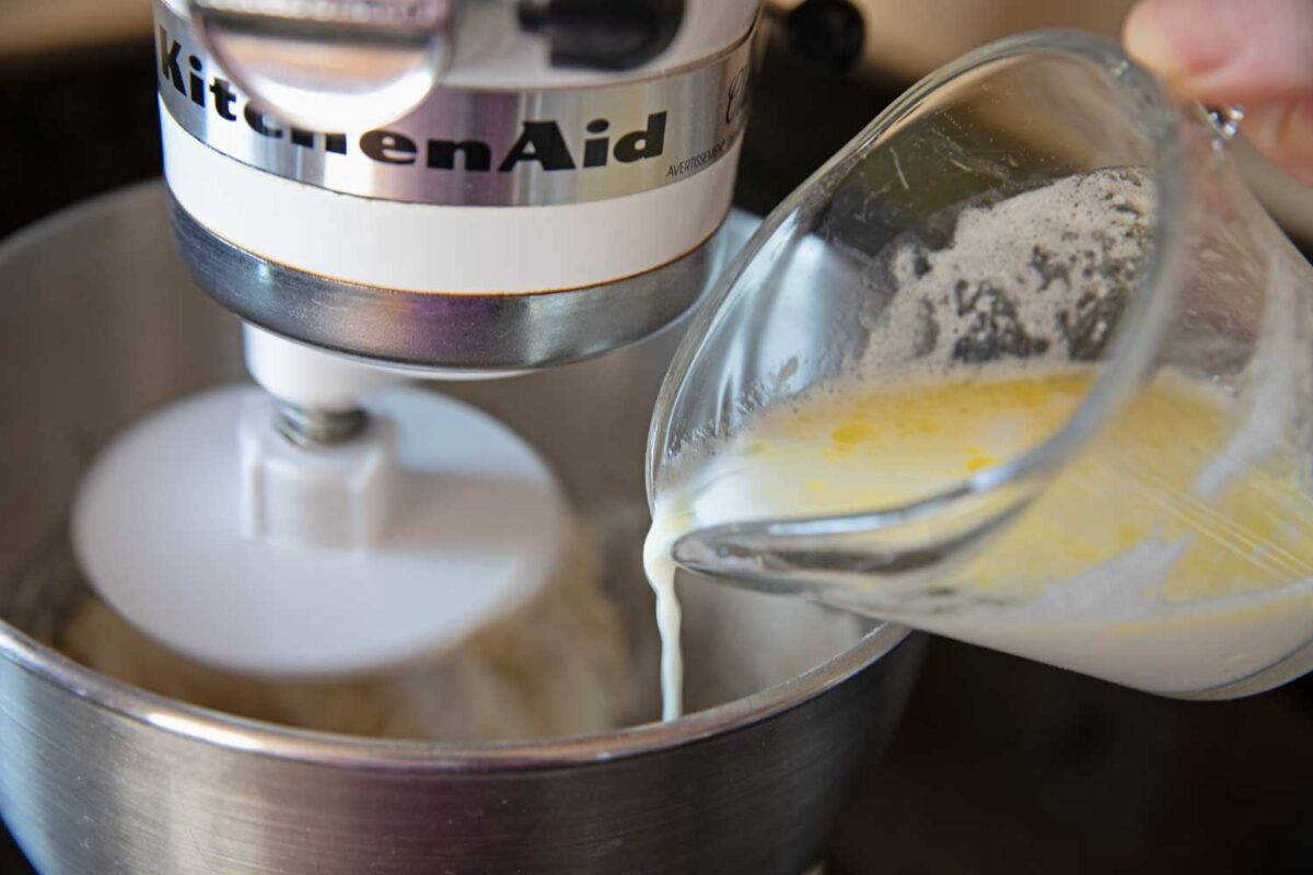 pouring butter and milk into the mixing bowl