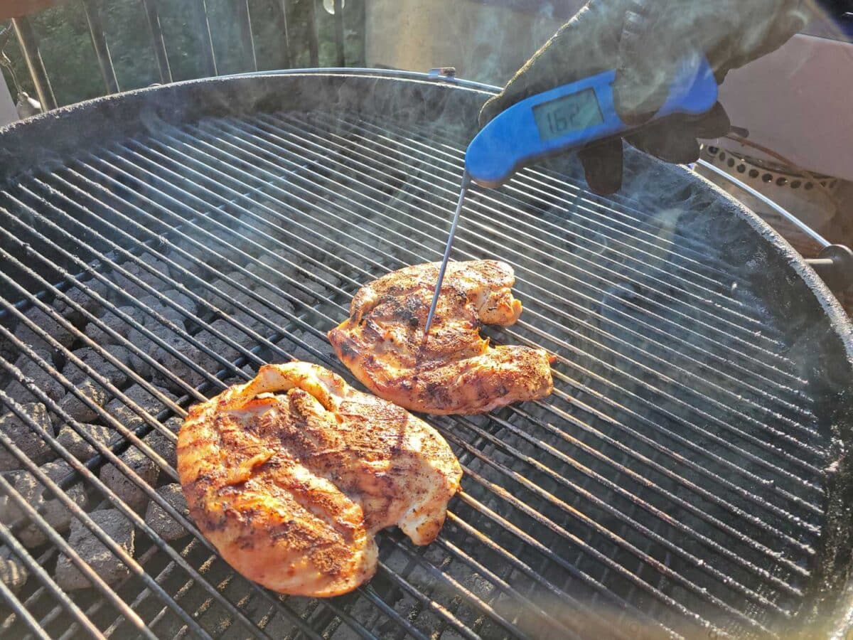 probing chicken with instant-read thermometer