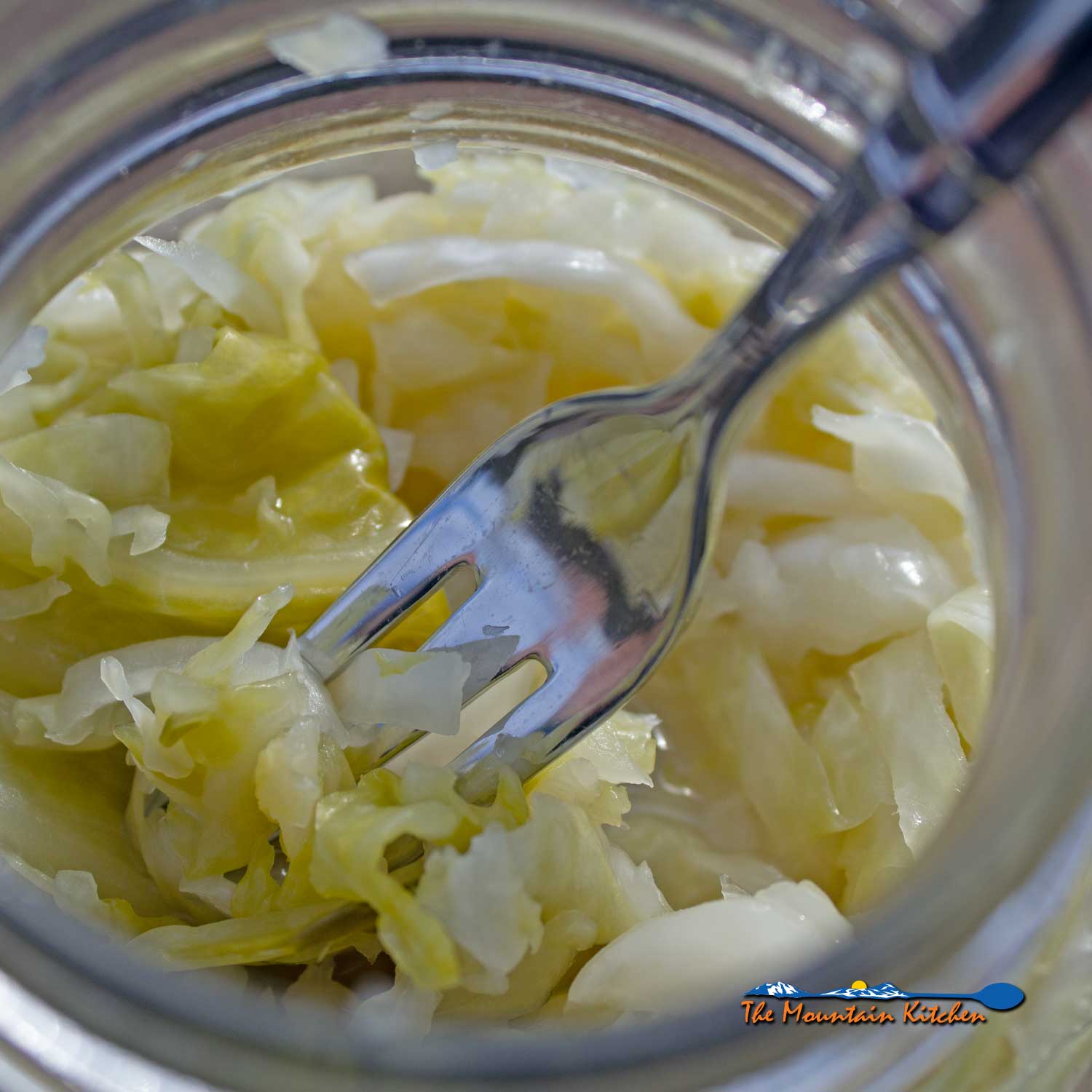 sauerkraut with fork in jar