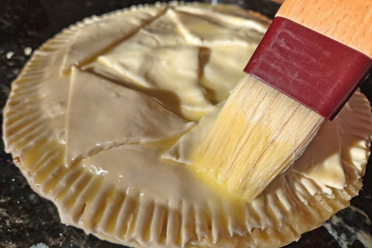 brushing egg wash on crust